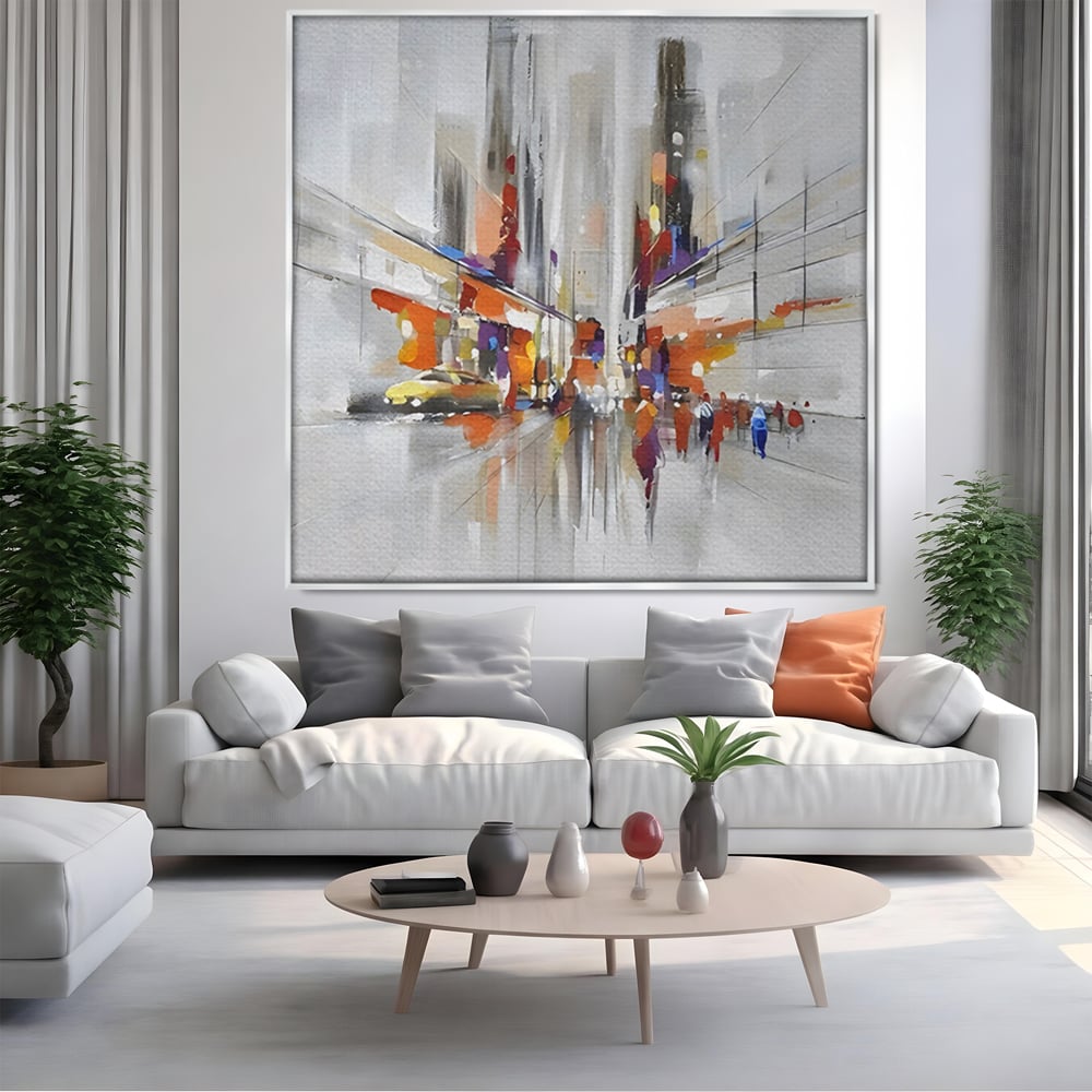 Tablou canvas cu pictura abstracta cu peisaj urban, in rama de aluminiu argintiu, pe perete intr-un living